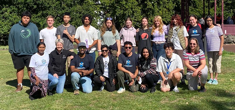 NanoCamp 2024 attendees, organisers and volunteers in Albert Park, Tāmaki Makaurau Auckland