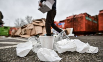 disposable plastic cups in front of rubbish bins getty images